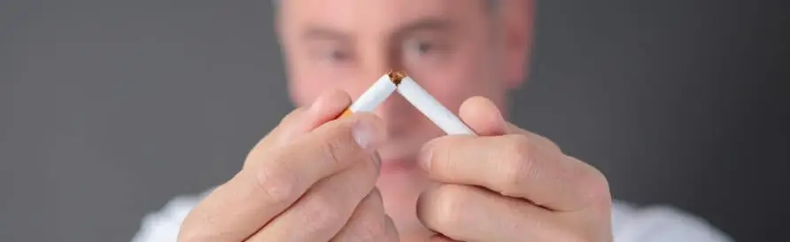 Man breaking cigarette